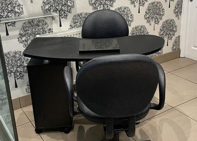 Cozy nail station at Zig-Zag Hair & Beauty, Normanton, England, GB, featuring chic black furnishings.