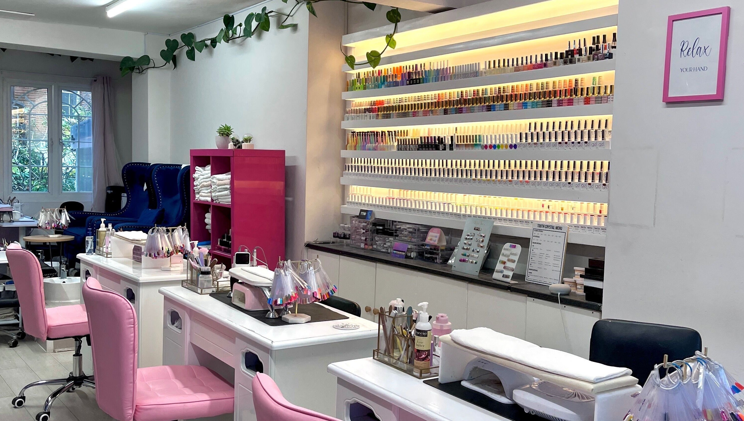 Milly and Jin, Hove, England, GB nail salon with colorful polish display and stations.