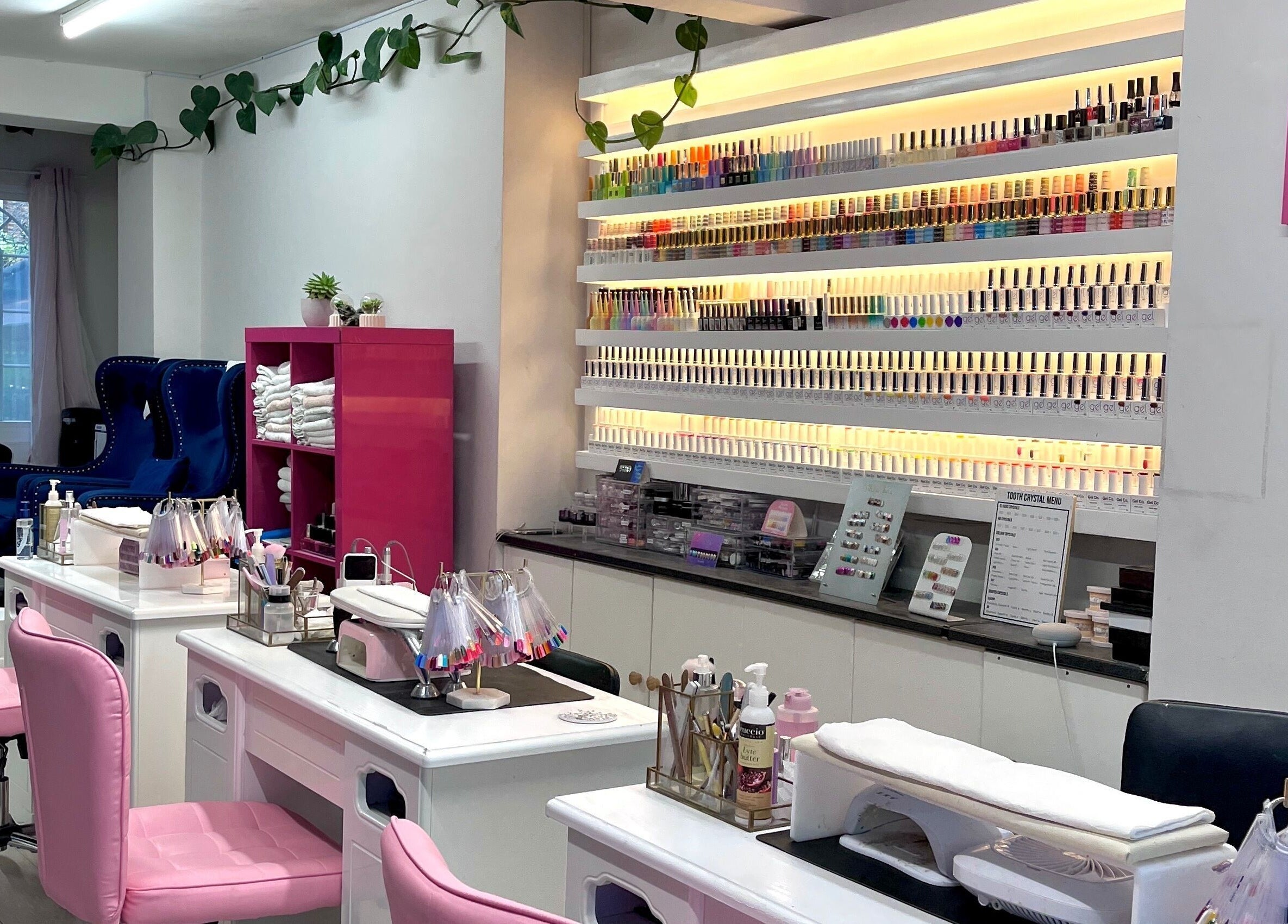 Milly and Jin, Hove, England, GB nail salon with colorful polish display and stations.