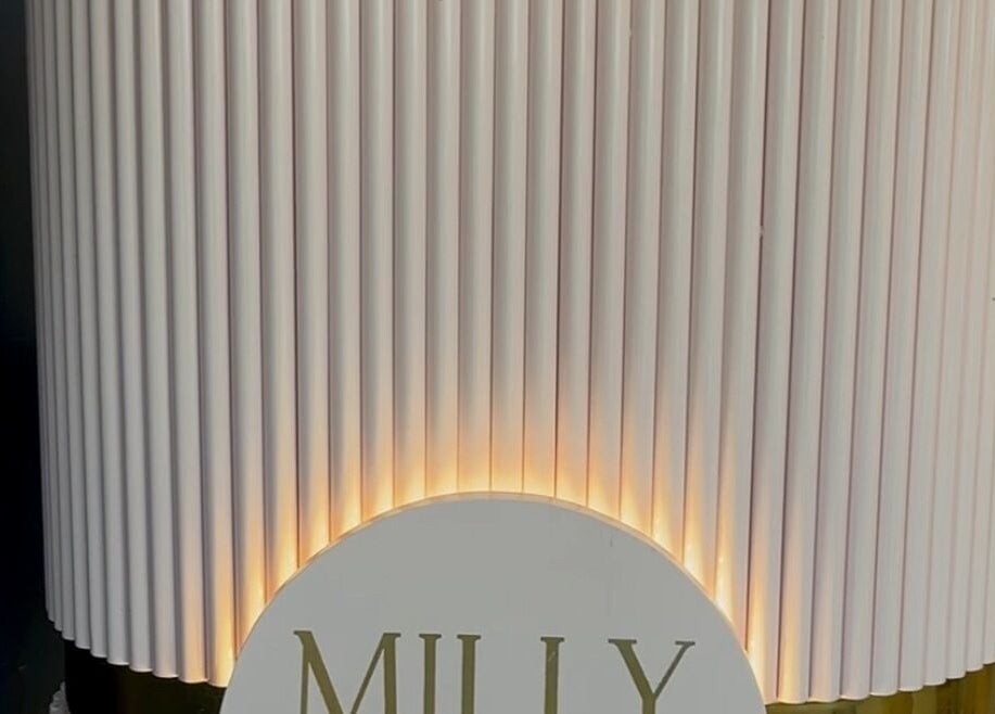 Illuminated wall display at Milly and Jin, Hove, England, GB, featuring soft vertical lines and elegant design.