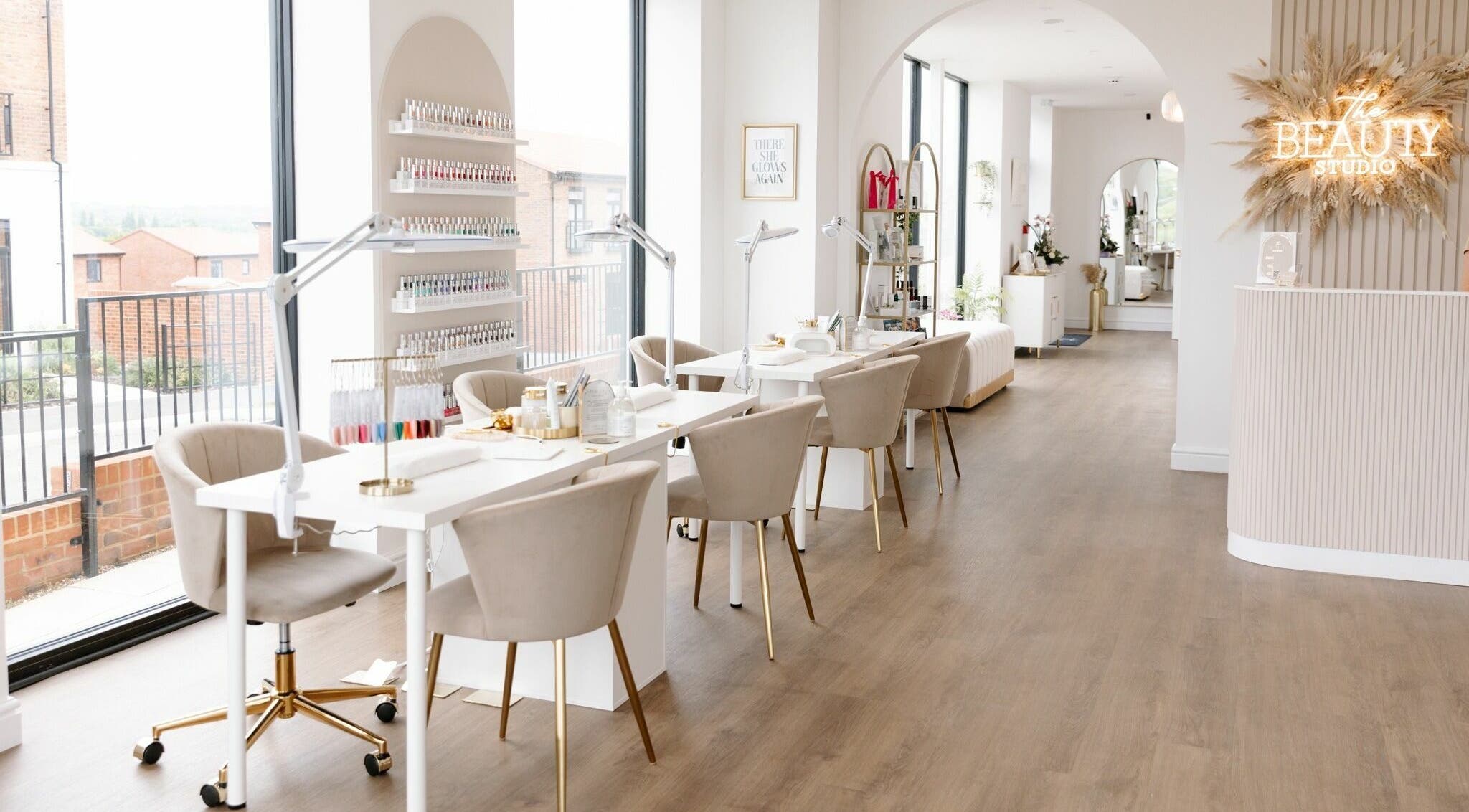 Bright, modern interior of The Beauty Studio in Canterbury, England, GB, featuring chic nail stations and a welcoming vibe.