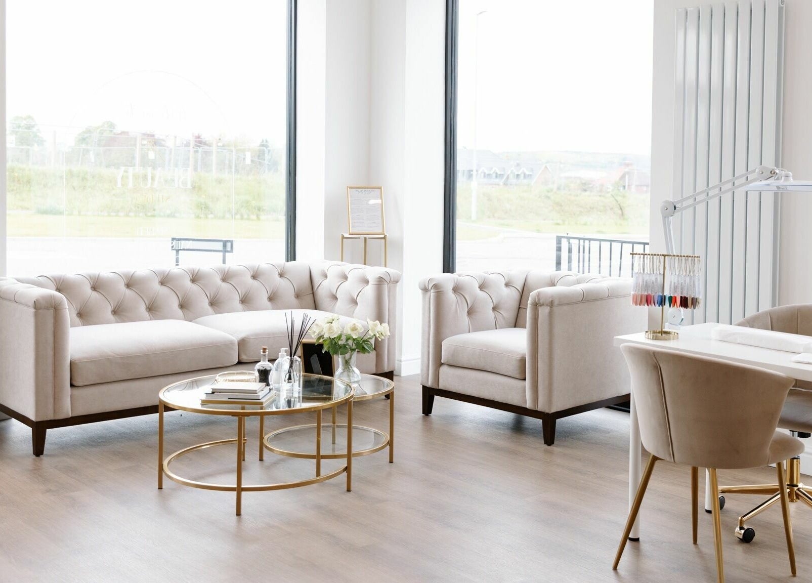 Elegant lounge area at The Beauty Studio, Canterbury, England, GB featuring plush sofas and a nail desk.