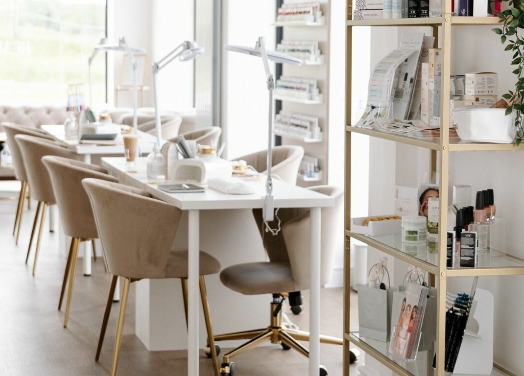 Bright, chic interior of The Beauty Studio in Canterbury, England, GB with modern nail stations and elegant decor.