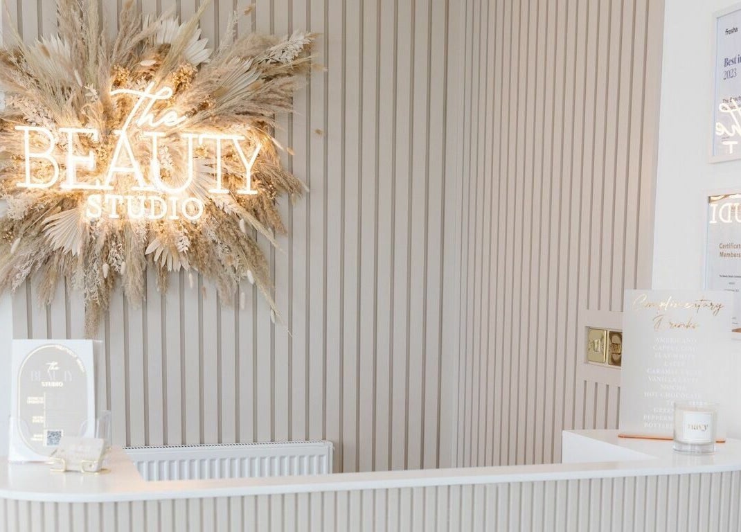 Chic reception at The Beauty Studio in Canterbury, England, GB, featuring illuminated logo and stylish decor.