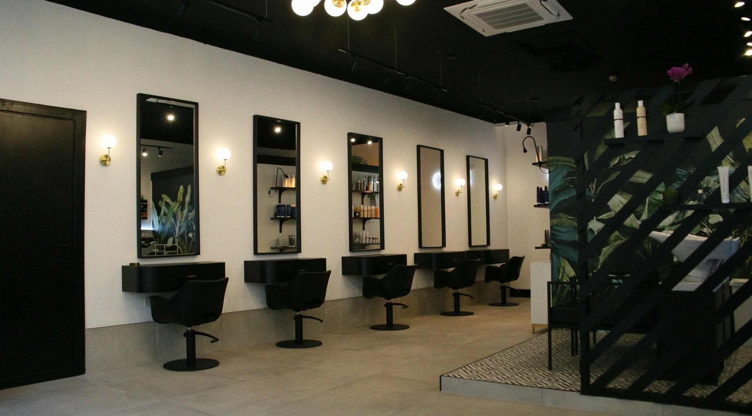 Modern salon interior at Simpson and Co, Stirling, Scotland, GB, featuring sleek chairs and mirrors.