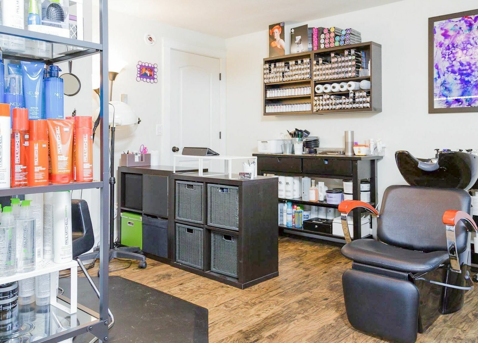 Stylish salon interior at Hair By Kyla, Vancouver, Washington, US with hair products and a modern styling chair.