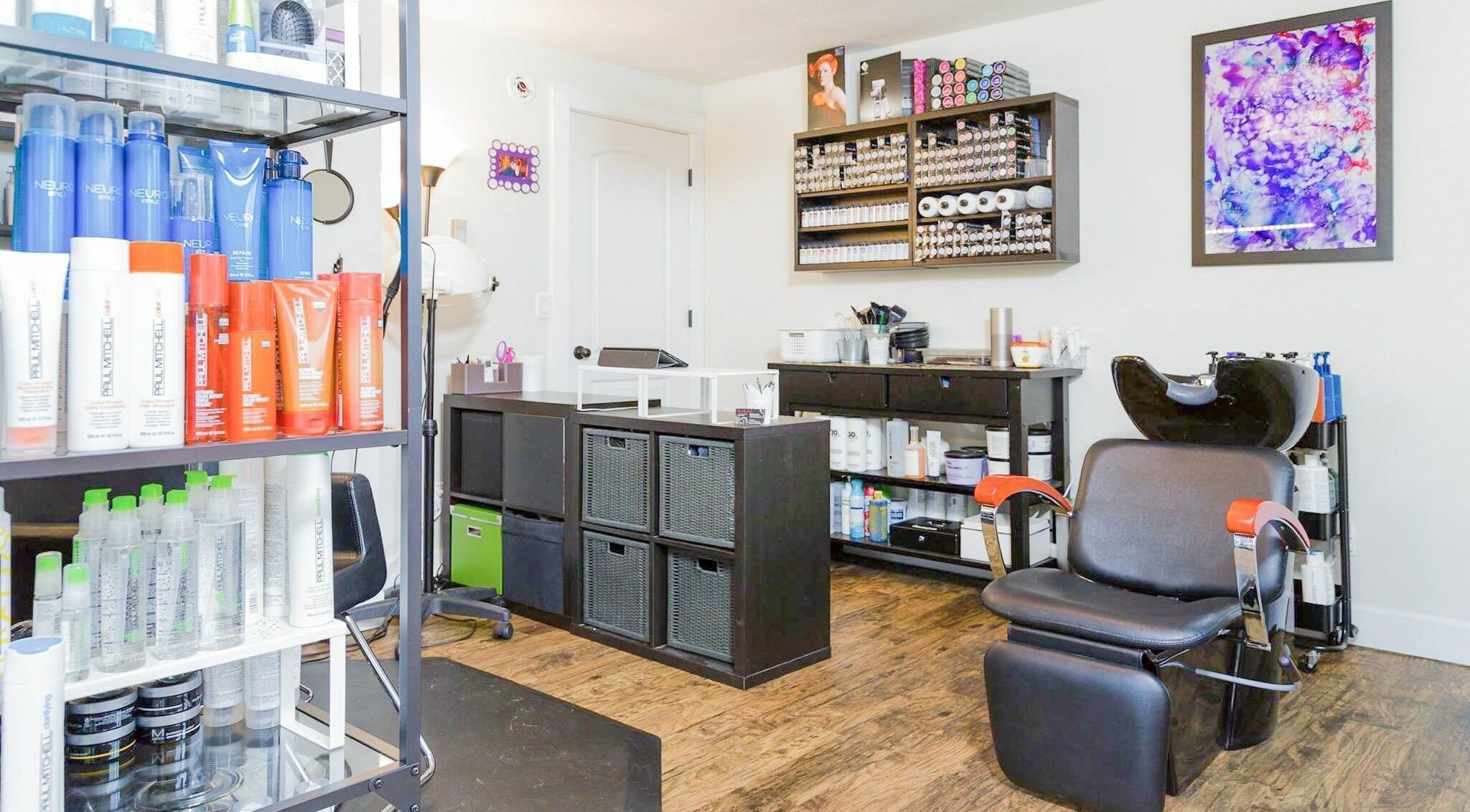 Stylish salon interior at Hair By Kyla, Vancouver, Washington, US with hair products and a modern styling chair.