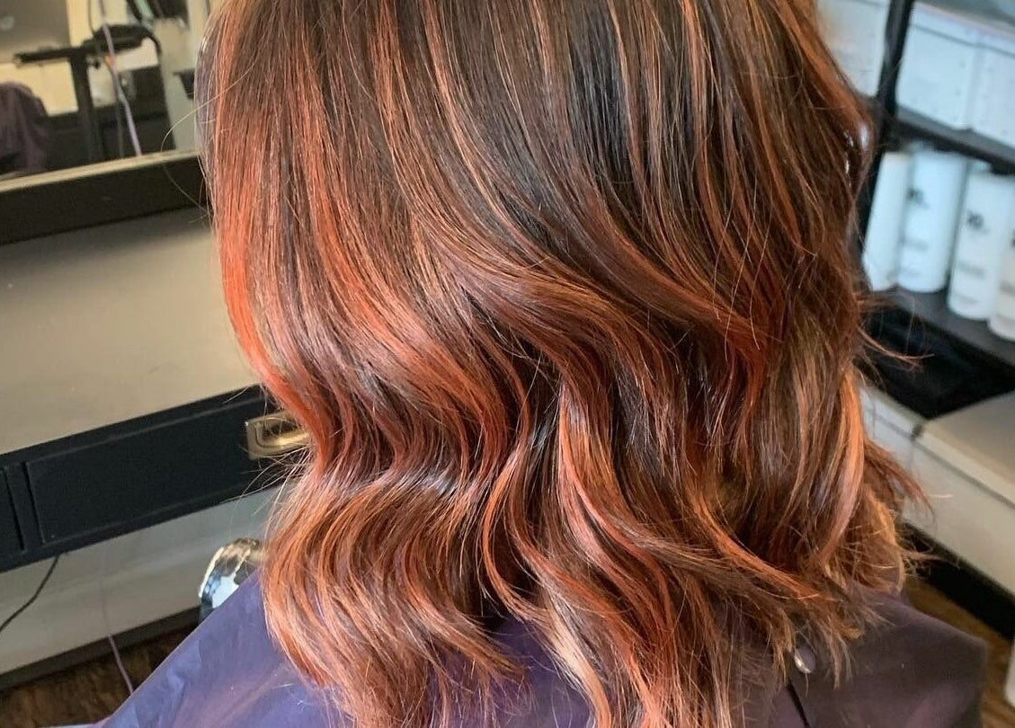 Stylish wavy haircut with warm highlights at Hair By Kyla, Vancouver, Washington, US.