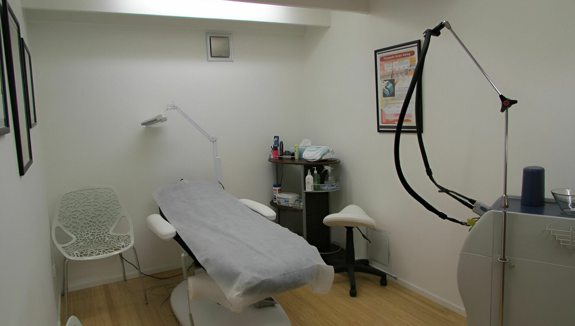 Helios Laser Studio's treatment room in Melbourne, Victoria, AU with modern laser equipment and sleek decor.