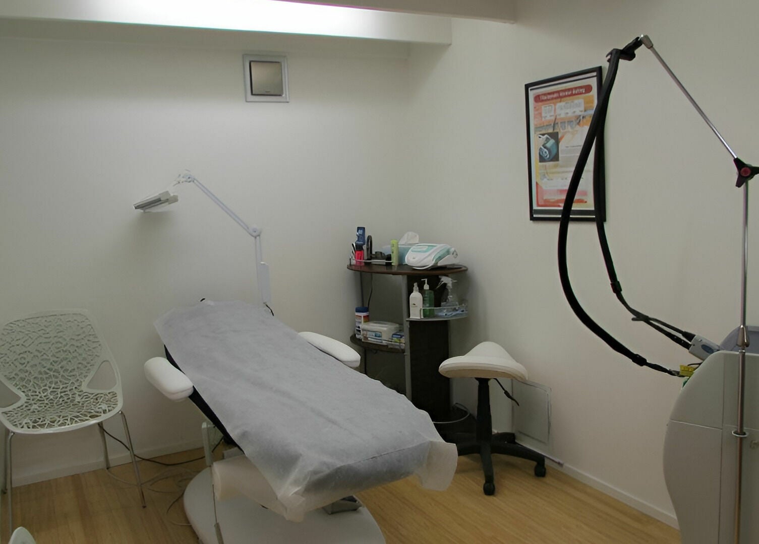 Helios Laser Studio's treatment room in Melbourne, Victoria, AU with modern laser equipment and sleek decor.