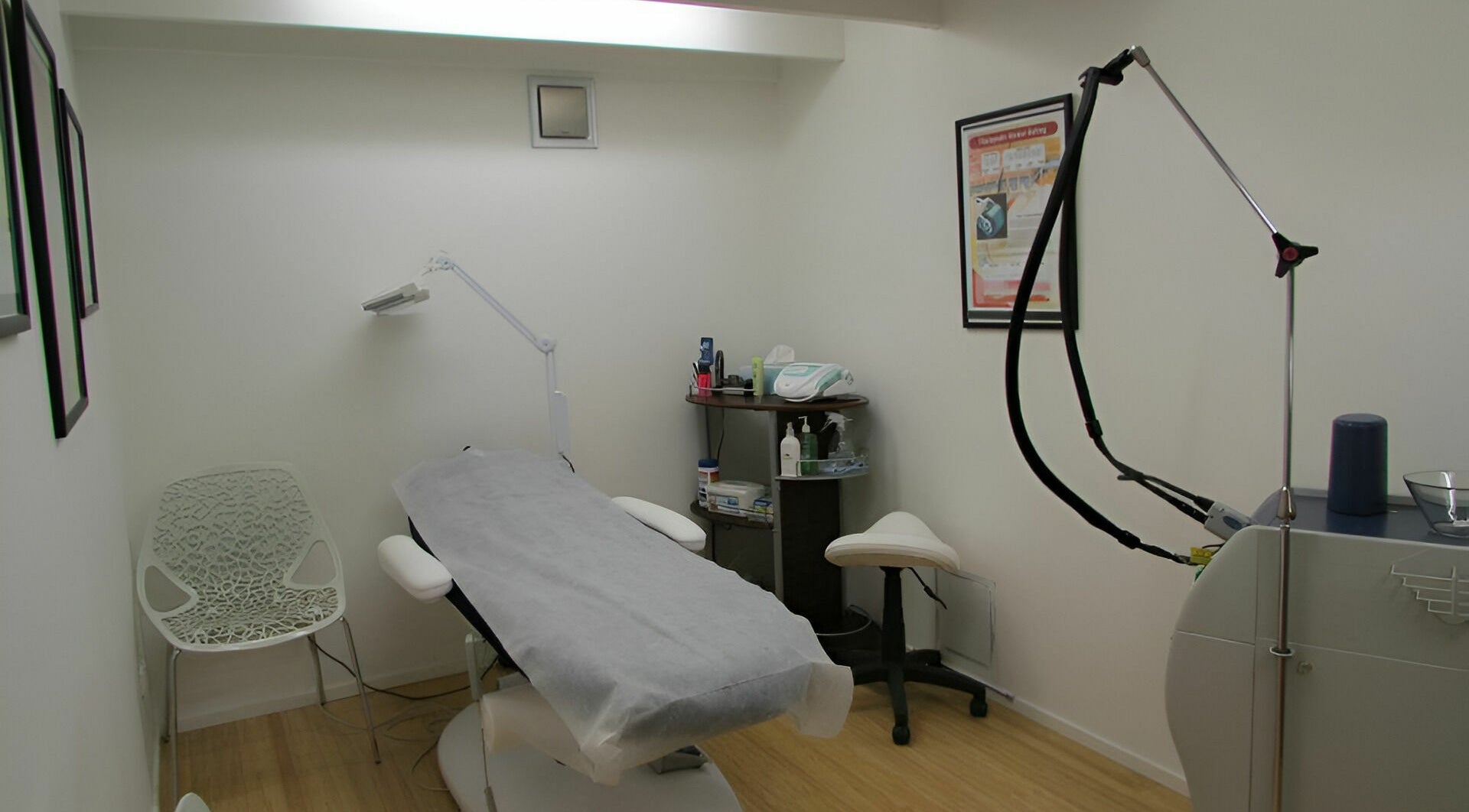 Helios Laser Studio's treatment room in Melbourne, Victoria, AU with modern laser equipment and sleek decor.