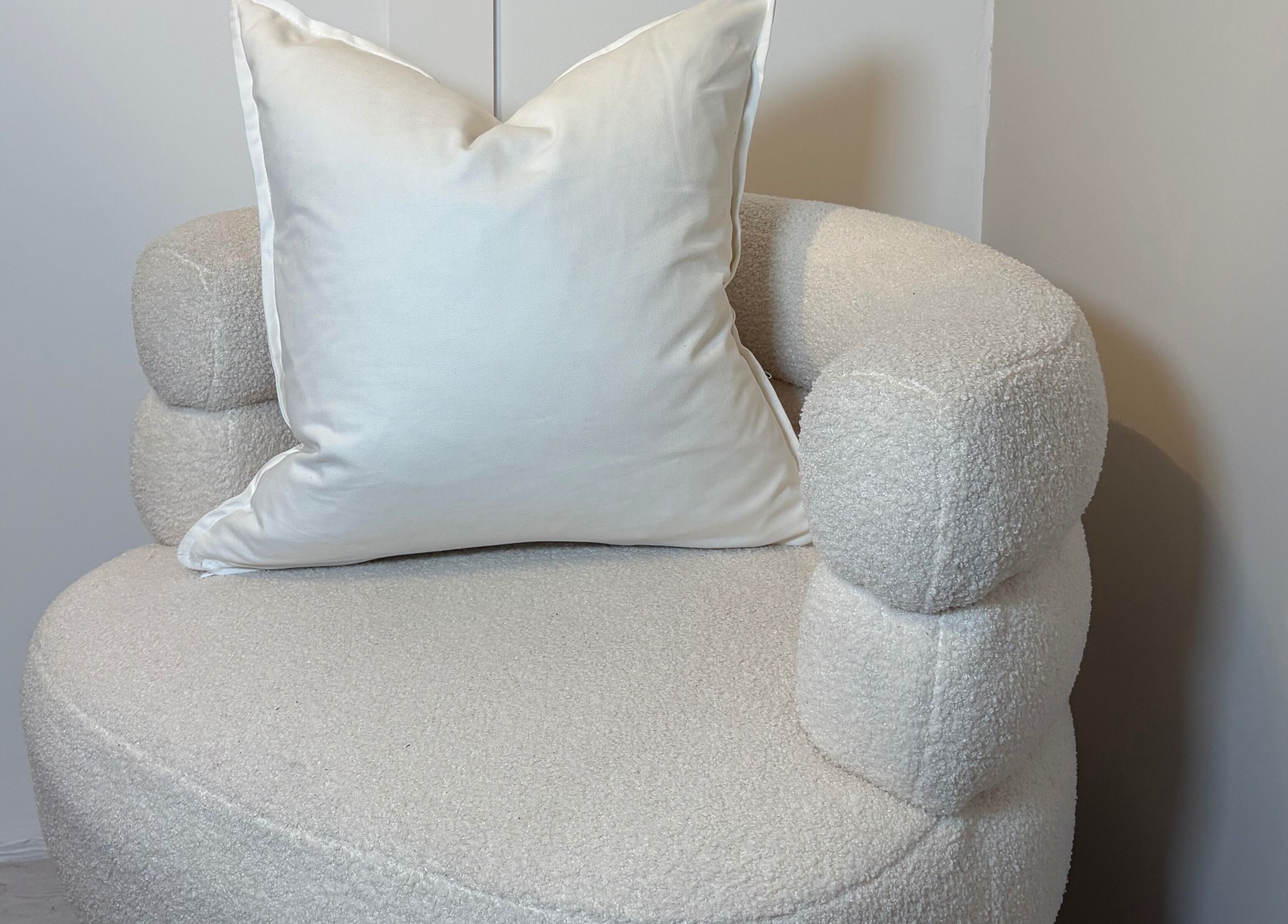 Elegant white cushioned chair at Mark One Beauty, Exeter, England, GB, perfect for relaxation and comfort.