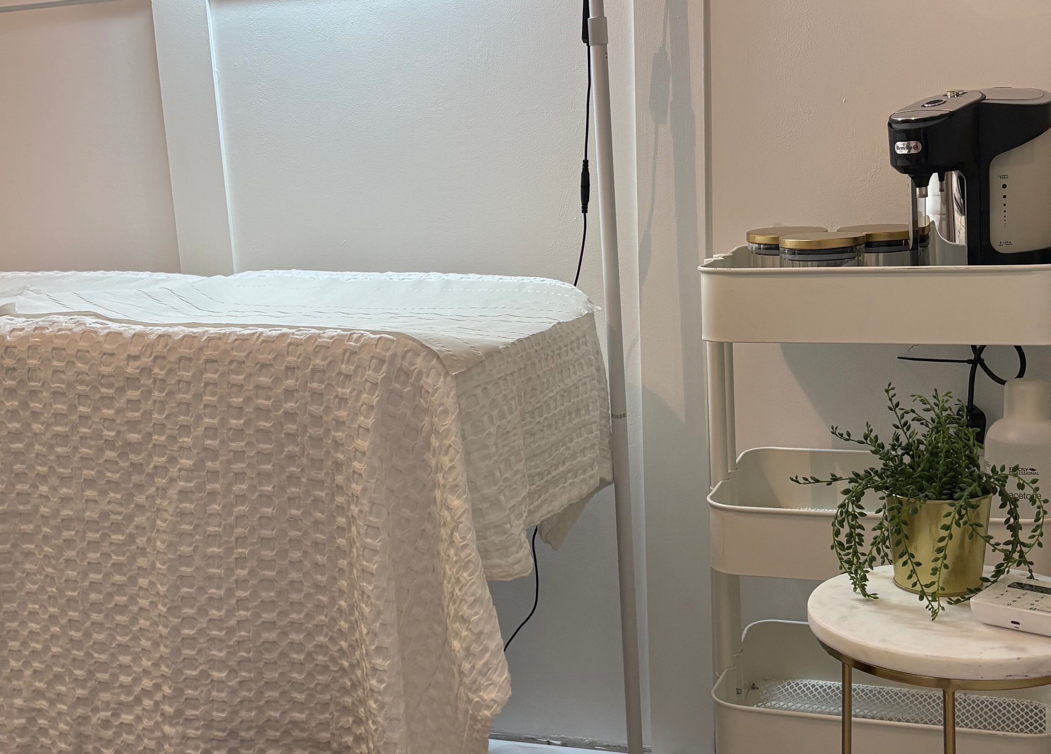 Calm treatment room at Mark One Beauty, Exeter, England, GB, with a cozy bed and soothing decor.