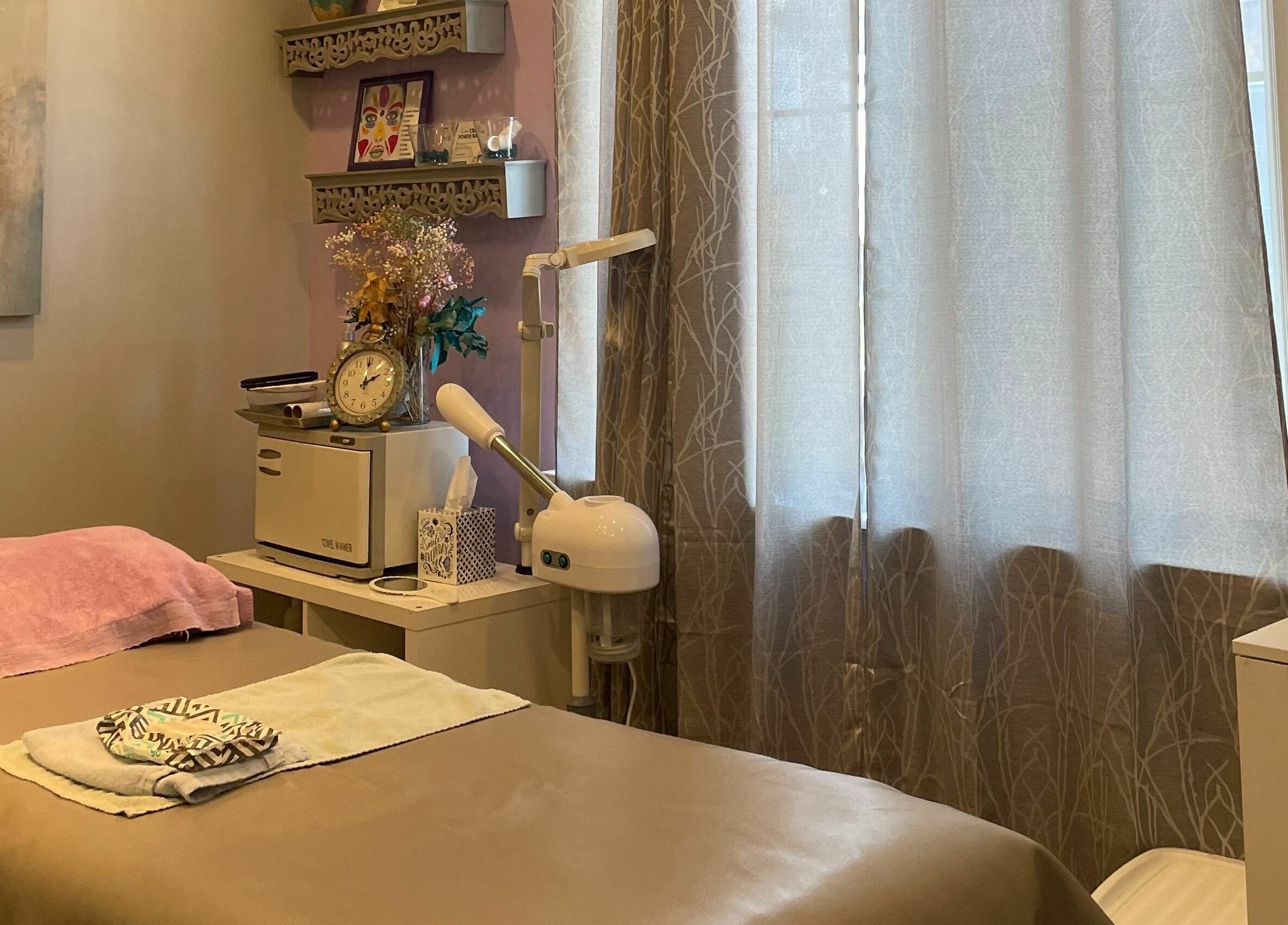 Relaxing treatment room at Always Smooth Waxing Studio, Taylorsville, Utah, US, with soft lighting and elegant decor.