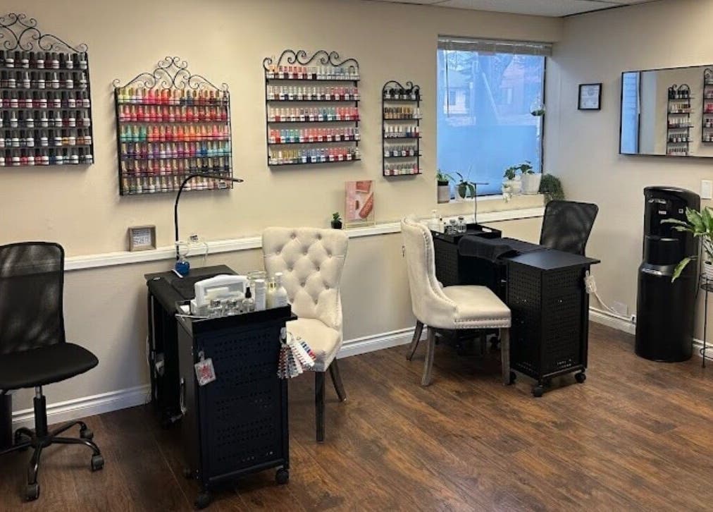 Stylish nail salon interior at Studio J, Sandpoint, Idaho, US, featuring chic seating and vibrant polish displays.