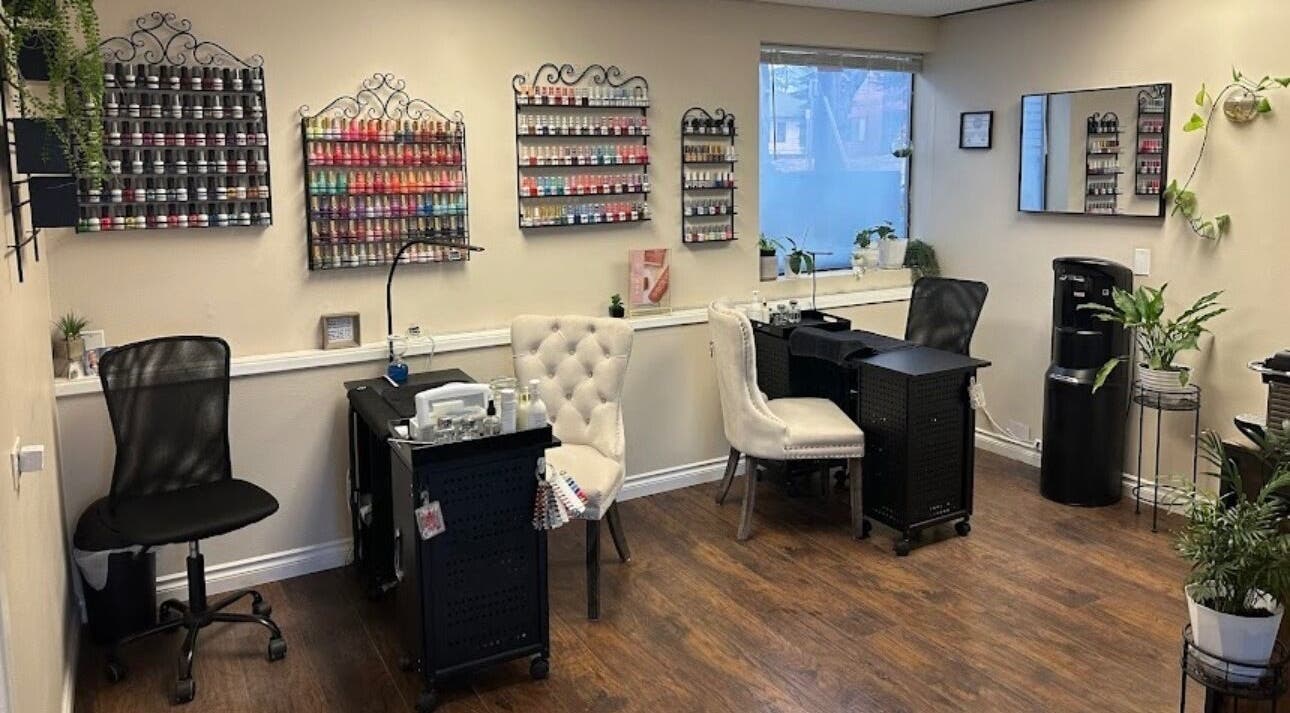 Stylish nail salon interior at Studio J, Sandpoint, Idaho, US, featuring chic seating and vibrant polish displays.