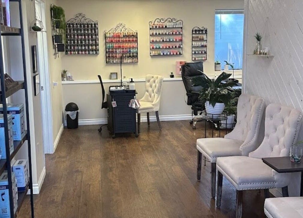 Chic interior of Studio J, Sandpoint, Idaho, US, featuring plush seating and nail polish displays.