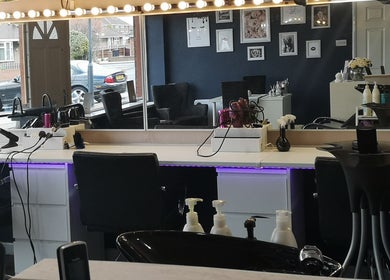 Chic salon interior at Diva's - The Home of Beauty in Doncaster, England, GB, showcasing styling stations.