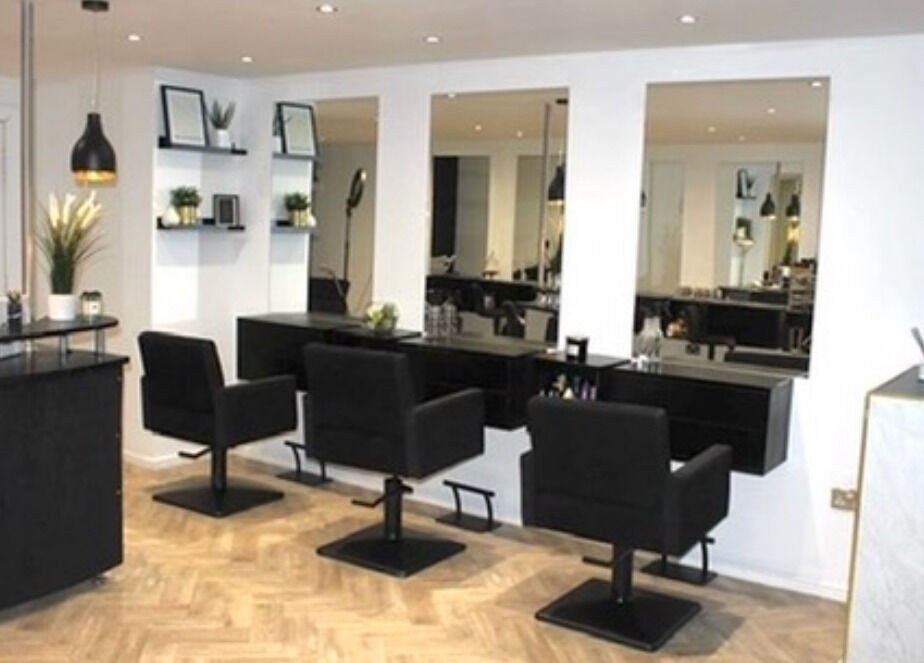 Chic salon interior at Image Beauty, Bearsden, Scotland, GB, with stylish black chairs and modern decor.