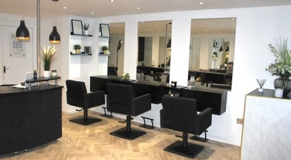 Chic salon interior at Image Beauty, Bearsden, Scotland, GB, with stylish black chairs and modern decor.
