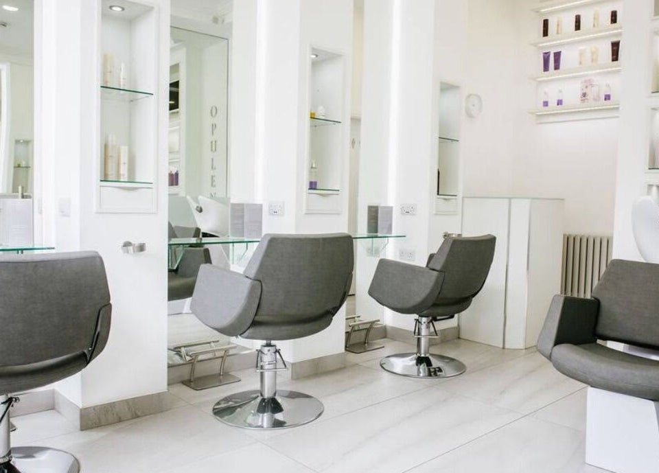 Modern salon chairs at Opulence Hairdressing in Lytham Saint Annes, England, GB, showcasing elegant design.