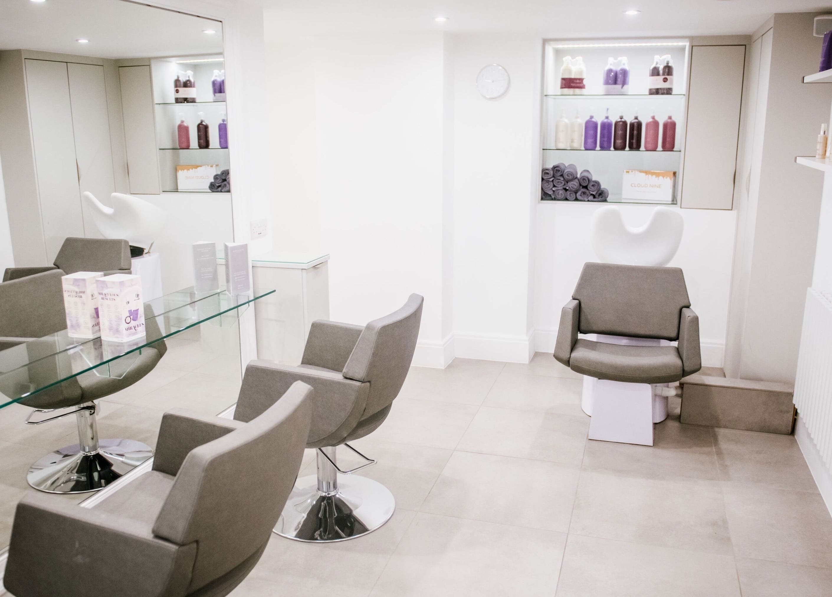 Interior of Opulence Hairdressing, Lytham Saint Annes, featuring modern chairs and premium products.
