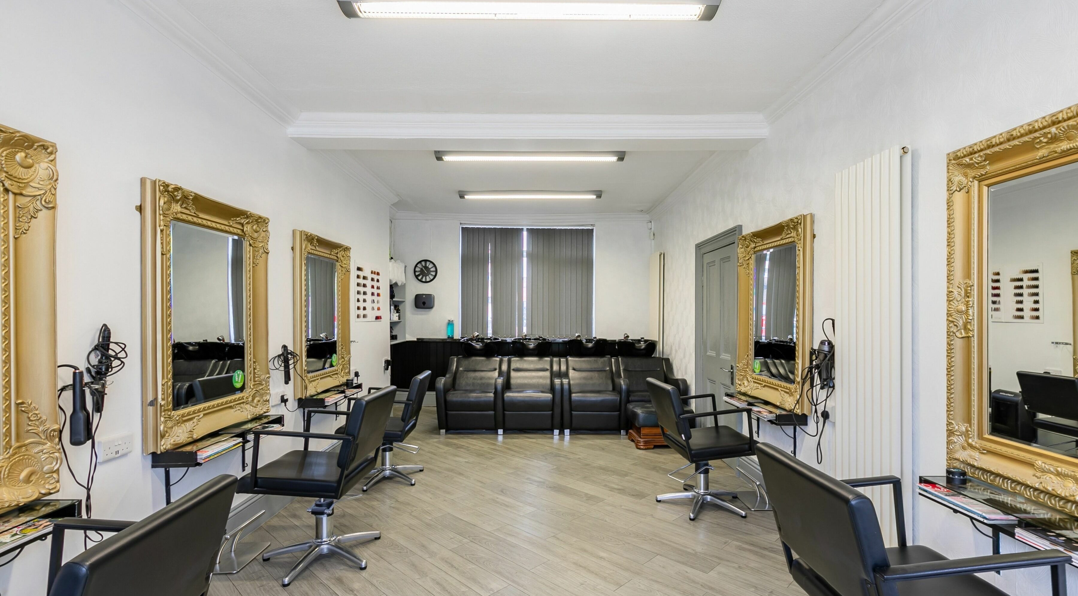Chic salon setting of HD Hair and Beauty in Cannock, England, GB featuring stylish mirrors and salon chairs.