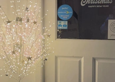 Festive lit tree by the entrance of Utopia Beauty and Skincare Belfast, Castlereagh, Northern Ireland, GB.