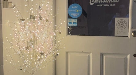 Festive lights adorn door at Utopia Beauty and Skincare Belfast, Castlereagh, Northern Ireland, GB.