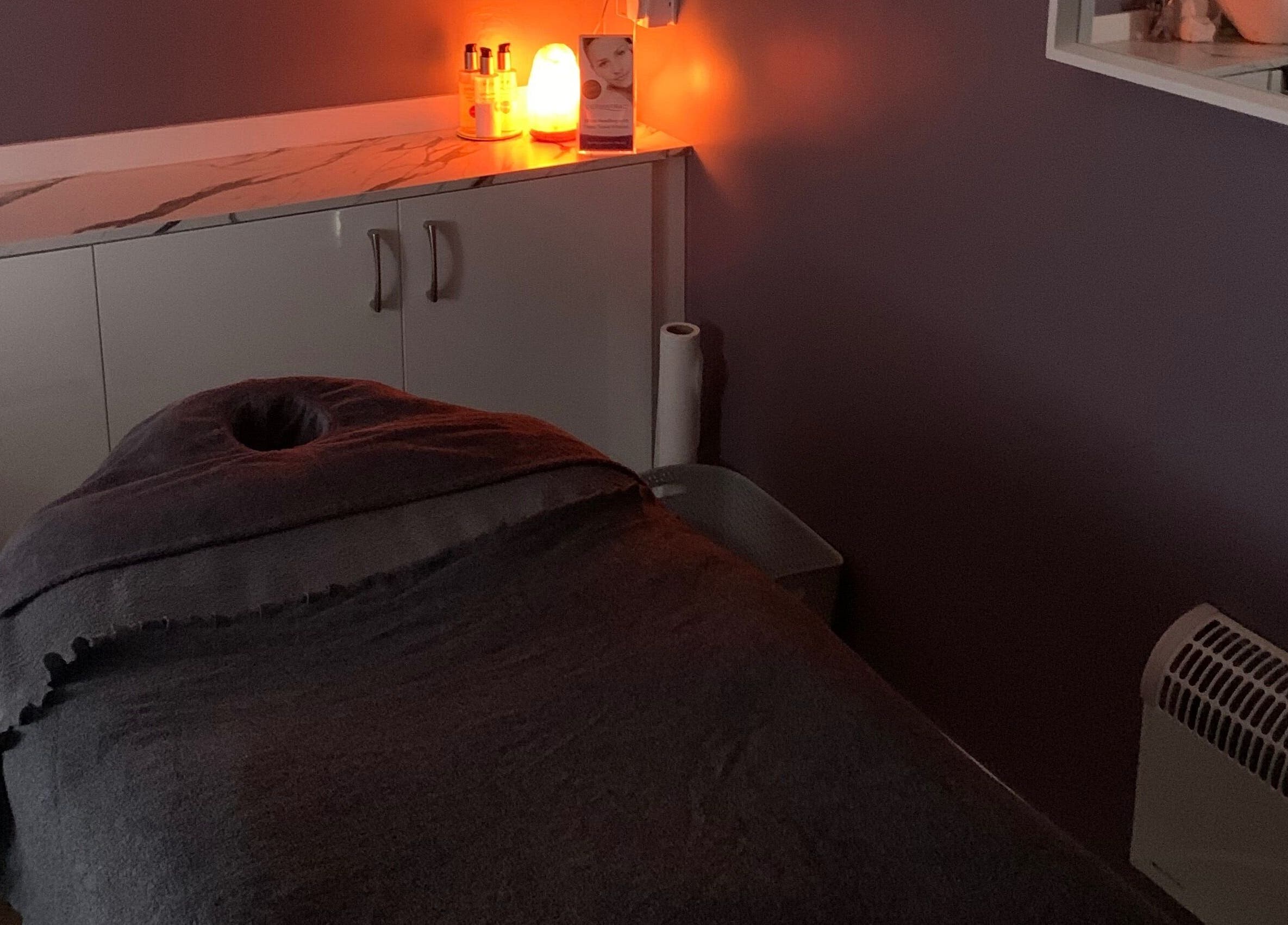 Calm treatment room at Utopia Beauty and Skincare Belfast, Castlereagh, Northern Ireland, GB with ambient lighting.