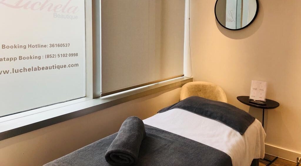 Cozy spa room at Luchela Beautique (Central) on Hong Kong Island, HK, featuring a massage table and decor.