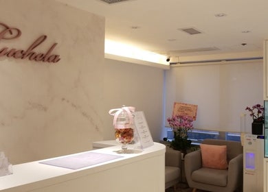 Reception area at Luchela Beautique (Central), Hong Kong Island, showcasing a chic interior with floral accents.