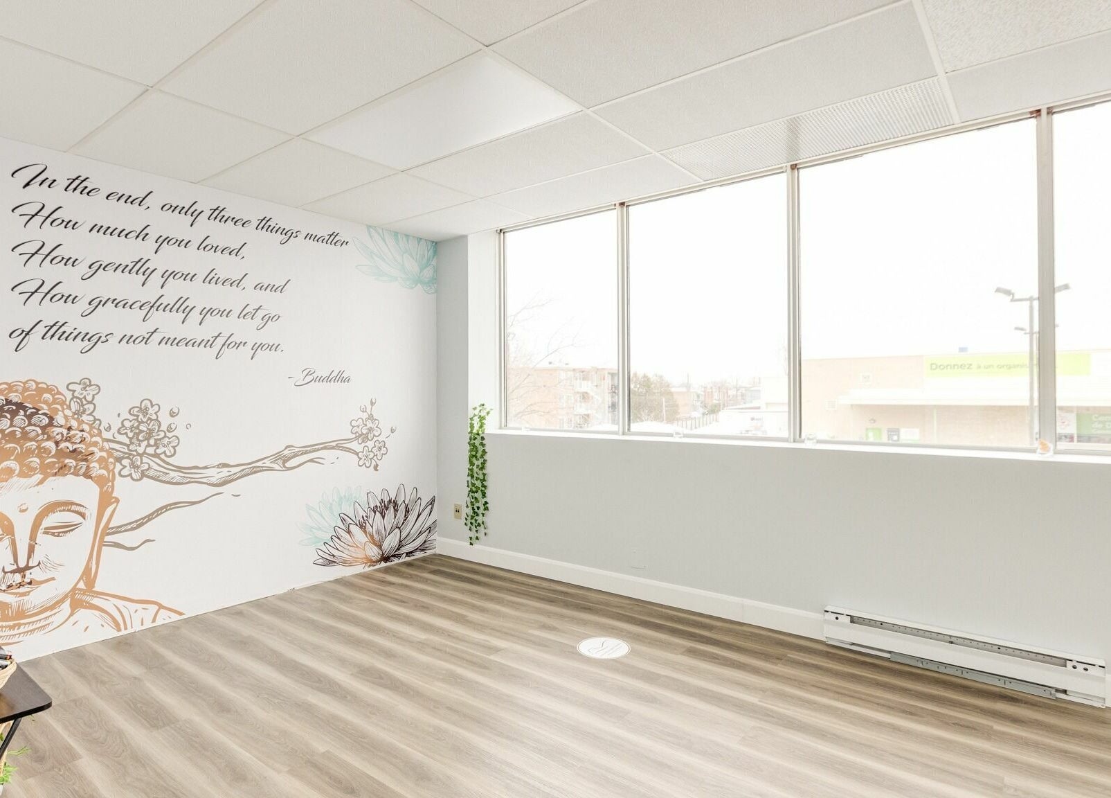 Tranquil room at Wellness Center Massotherapie Sandra, Laval, Québec, CA with Buddha mural and large windows.