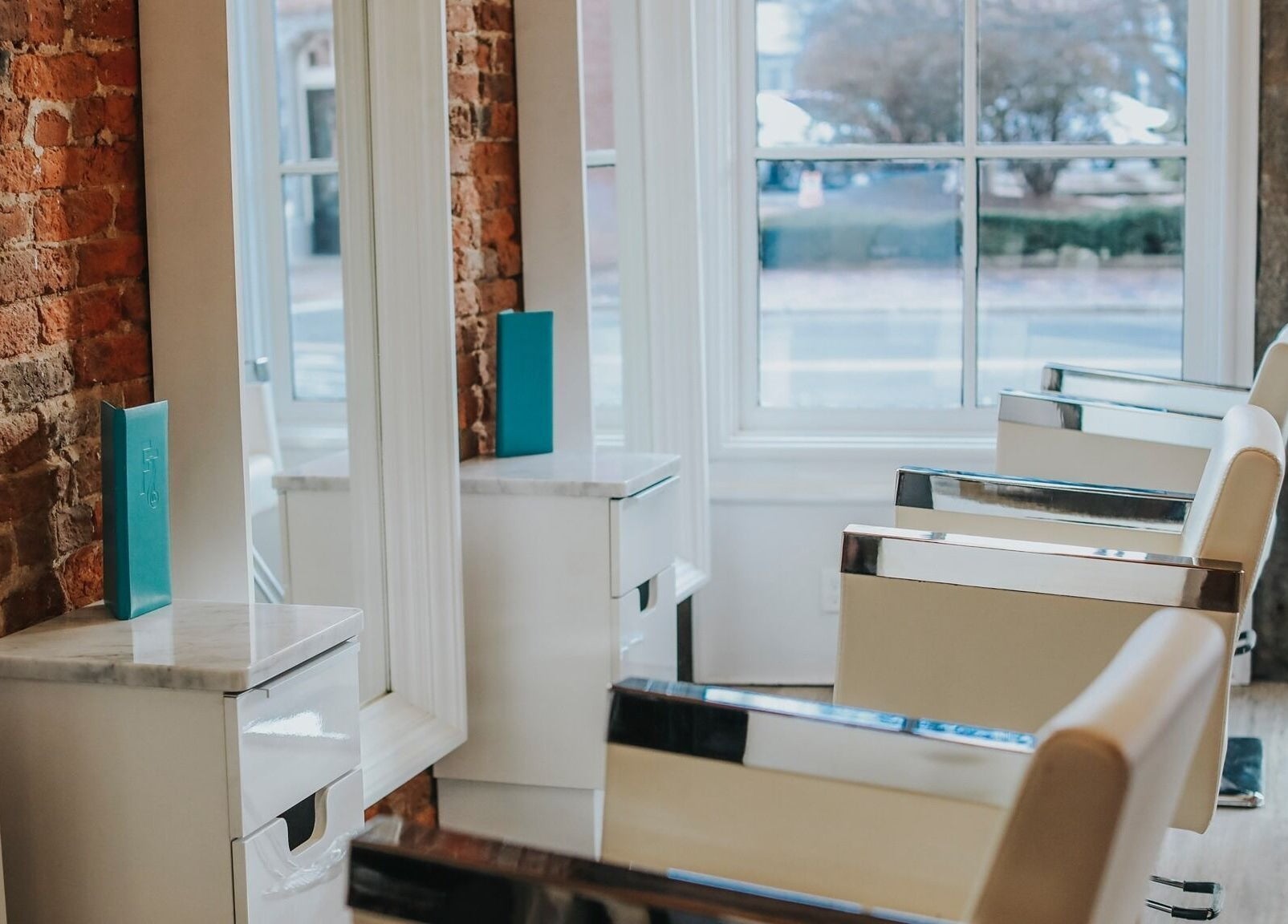 Modern salon chairs at French Twist Salon in Newburyport, Massachusetts with natural light from large windows.