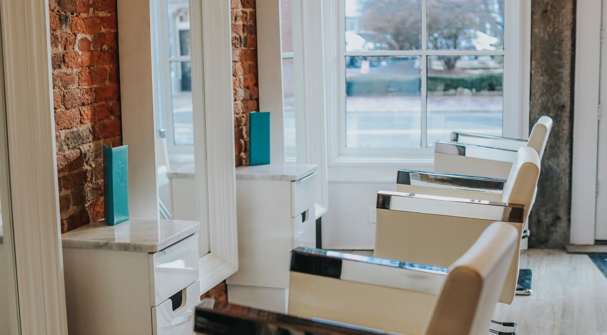 Modern salon chairs at French Twist Salon in Newburyport, Massachusetts with natural light from large windows.