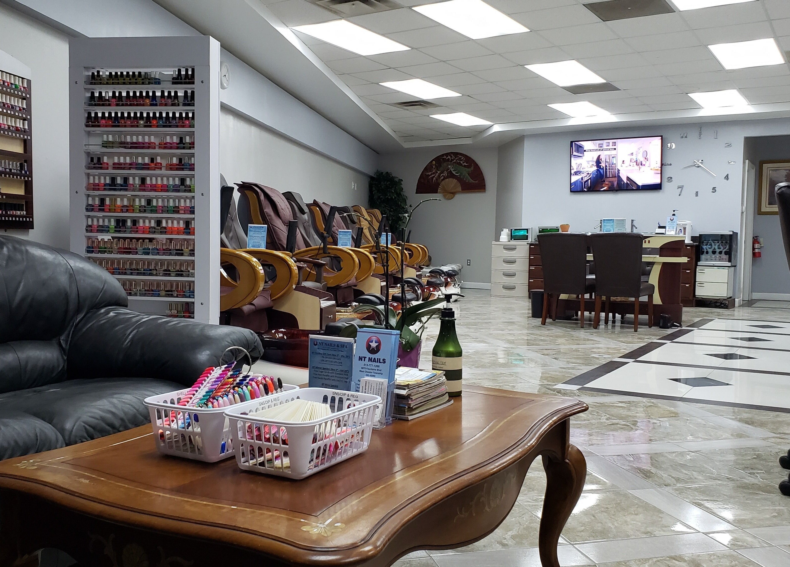 Interior of NT Nails and Spa in West Chester, Ohio, US, featuring cozy seating and a vast polish selection.