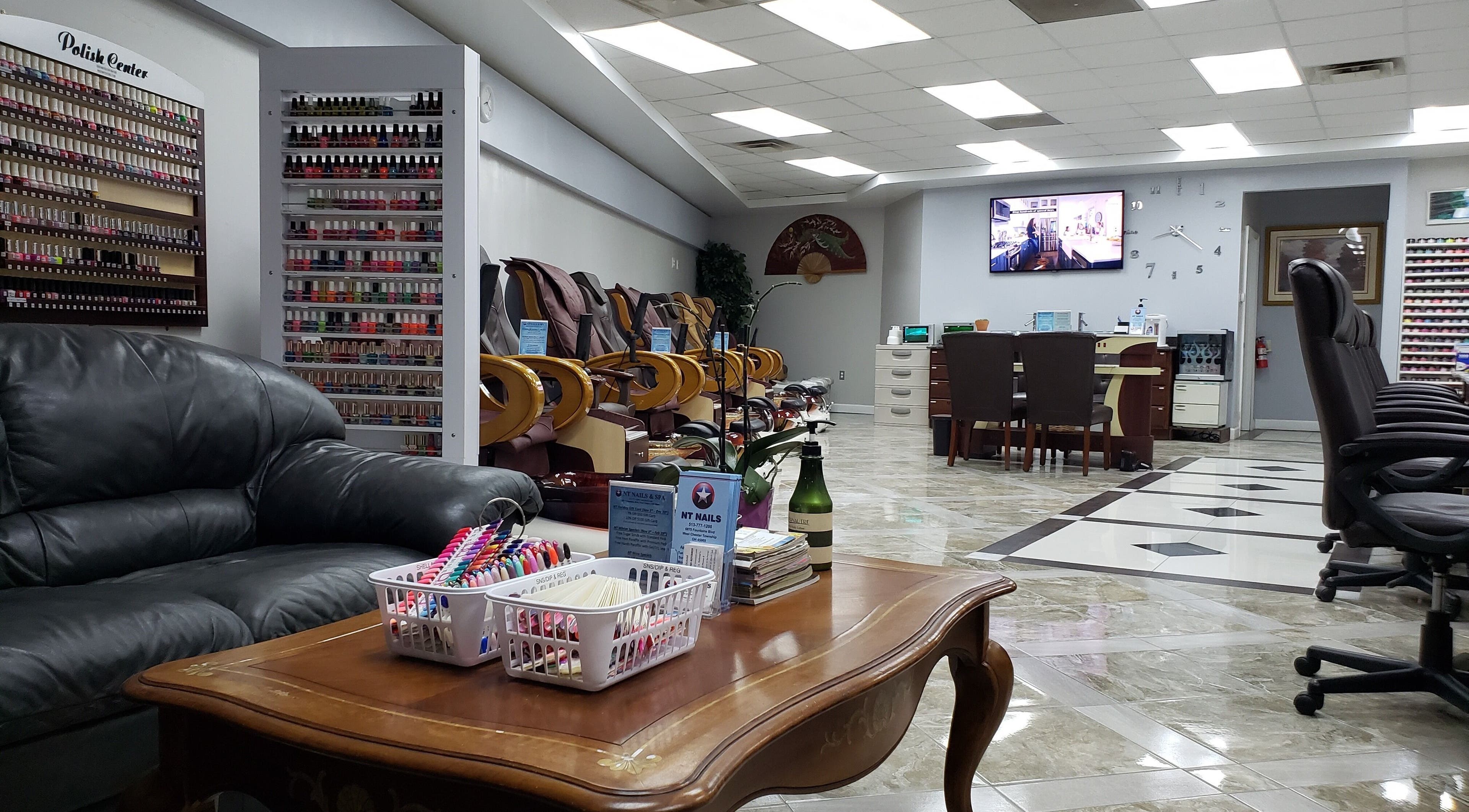 Interior of NT Nails and Spa in West Chester, Ohio, US, featuring cozy seating and a vast polish selection.