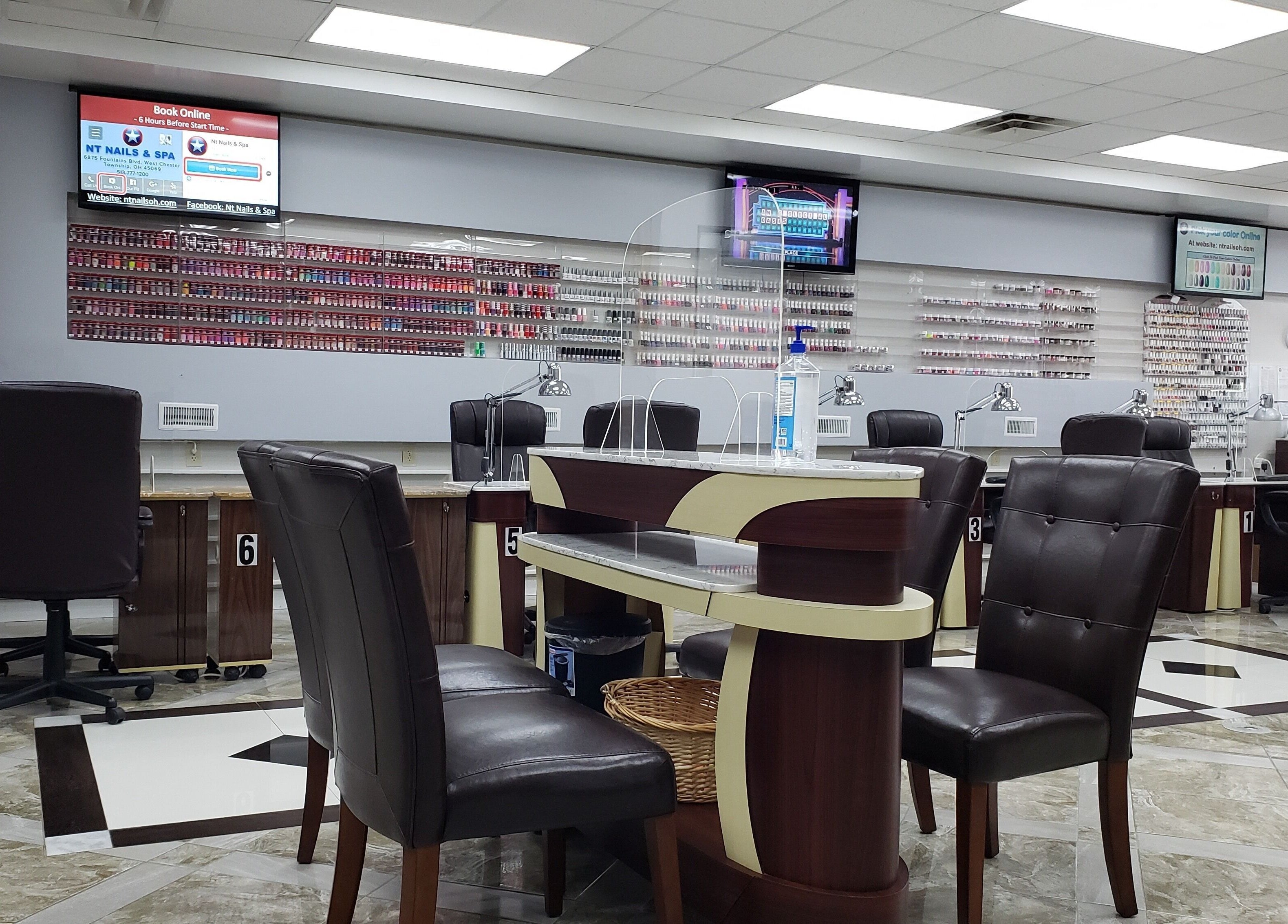 Interior of NT Nails and Spa in West Chester, Ohio, US featuring modern nail stations and polish display.