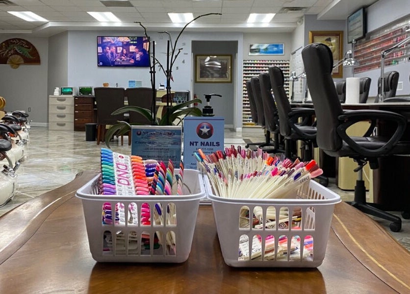 Interior of NT Nails and Spa, West Chester, Ohio, US showcasing nail polish and manicure stations.
