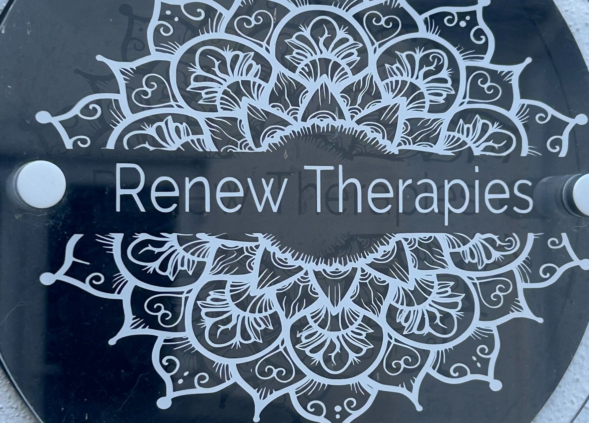 Intricate sign of Renew Therapies Sandyford, County Dublin, IE, showcasing elegant floral design.