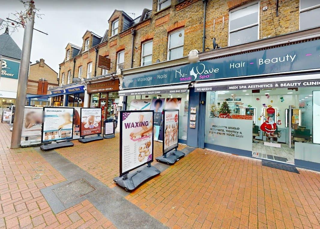 Exterior of Nu Wave Laser Clinic, London, England, GB, showcasing vibrant signage and welcoming entryway.
