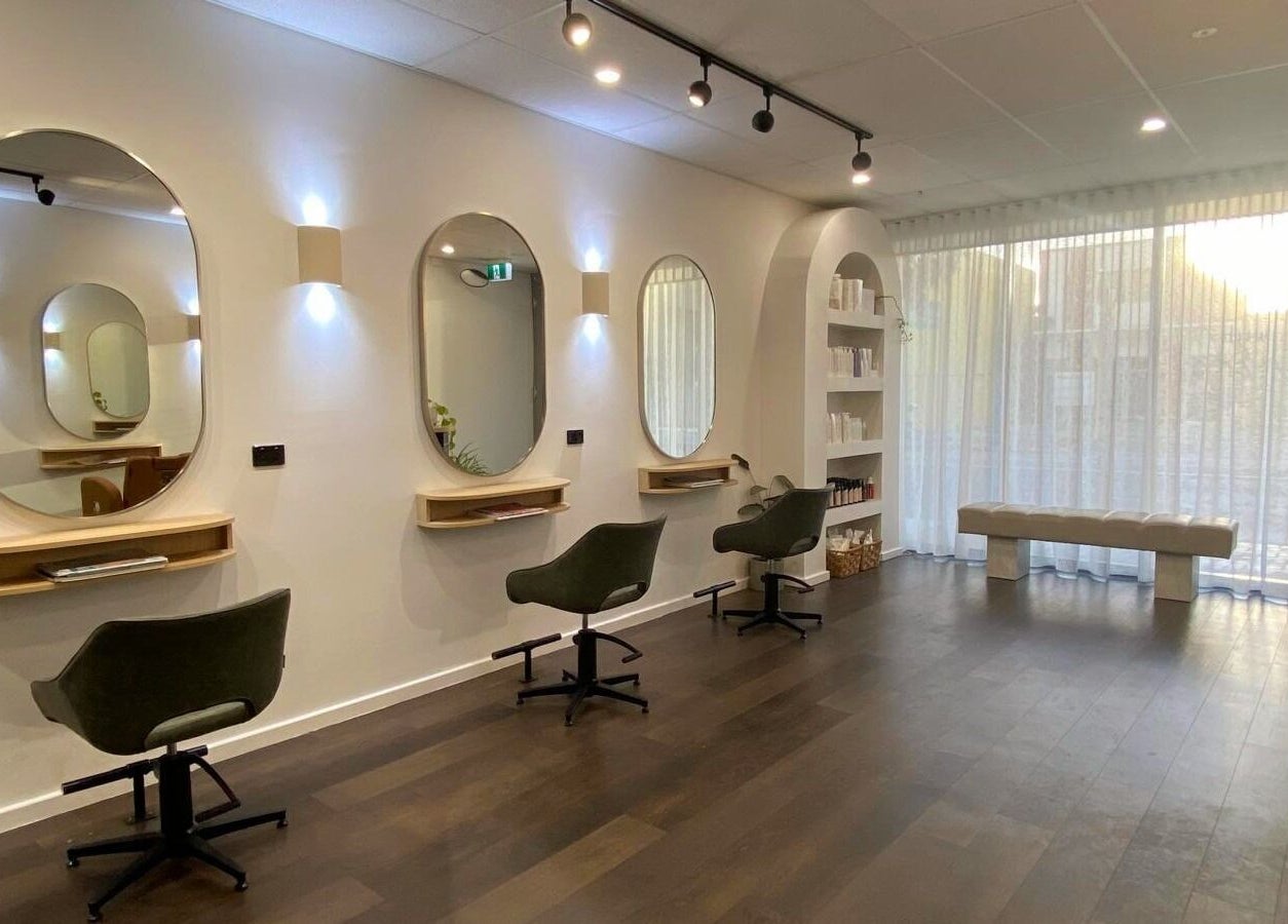 Perth Curls salon in Leederville, Western Australia with elegant chairs and modern mirrors.