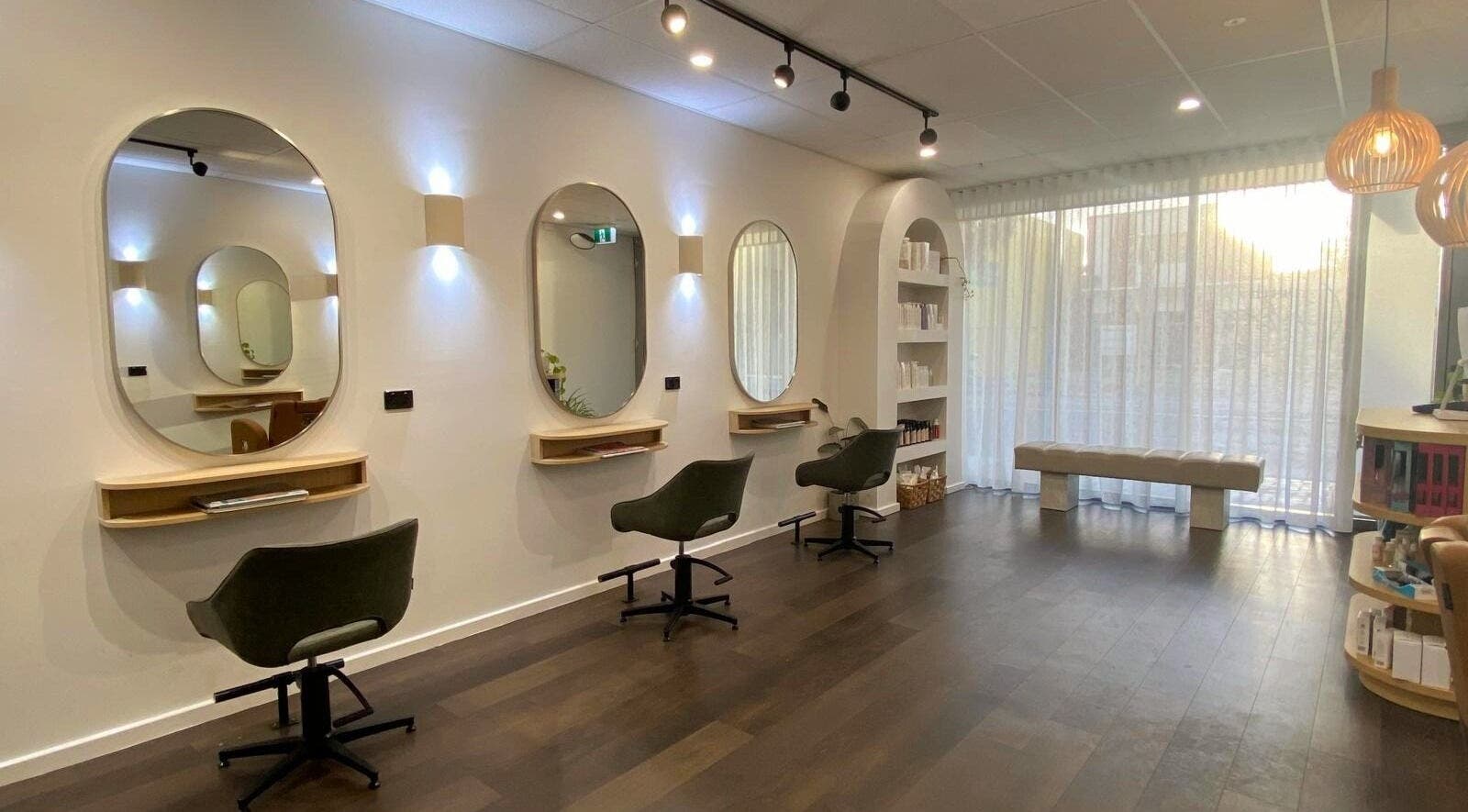 Perth Curls salon in Leederville, Western Australia with elegant chairs and modern mirrors.