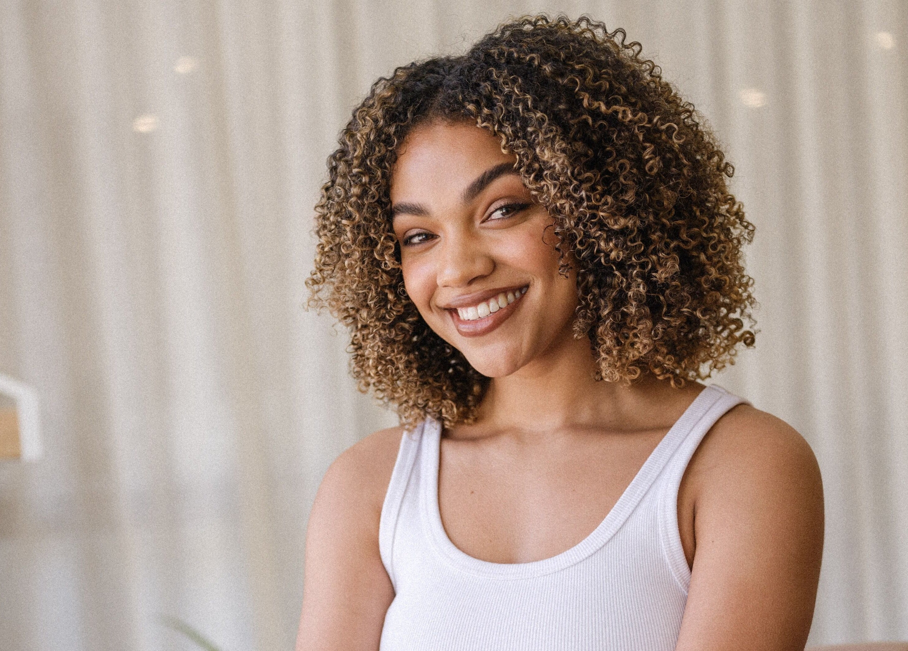 Smiling person with curly hair at Perth Curls, Leederville, Western Australia, AU.