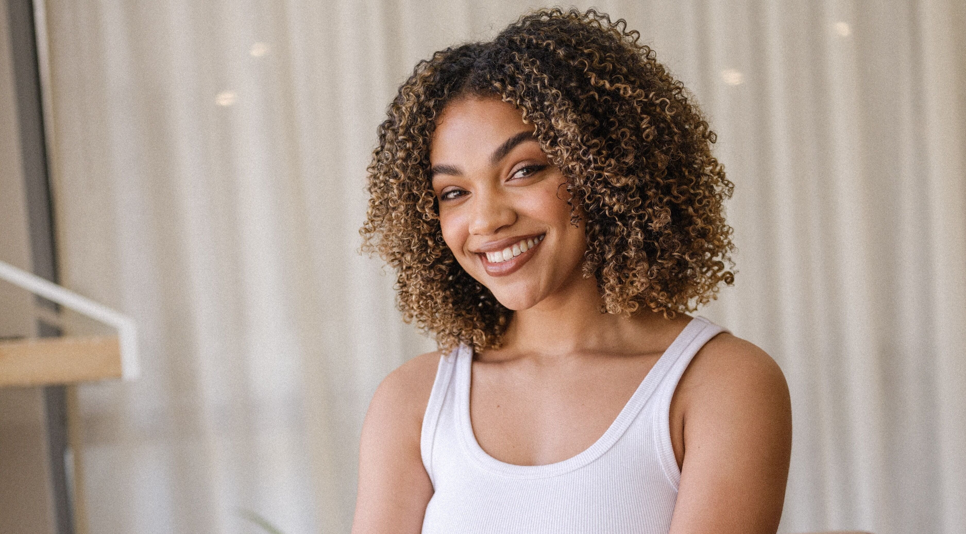 Smiling person with curly hair at Perth Curls, Leederville, Western Australia, AU.