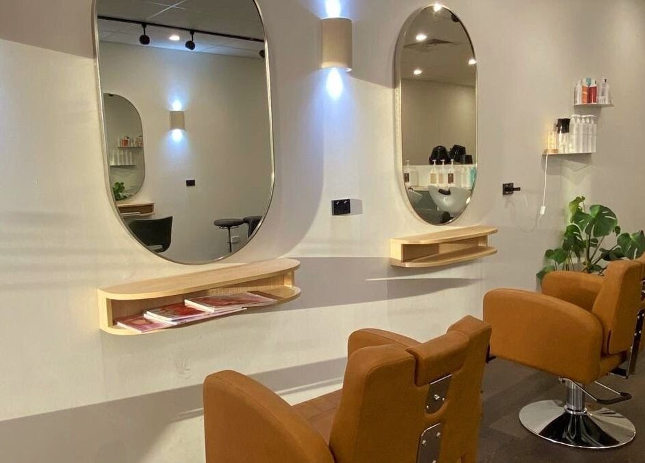 Elegant salon interior of Perth Curls, Leederville, Western Australia, AU featuring stylish stations and mirrors.