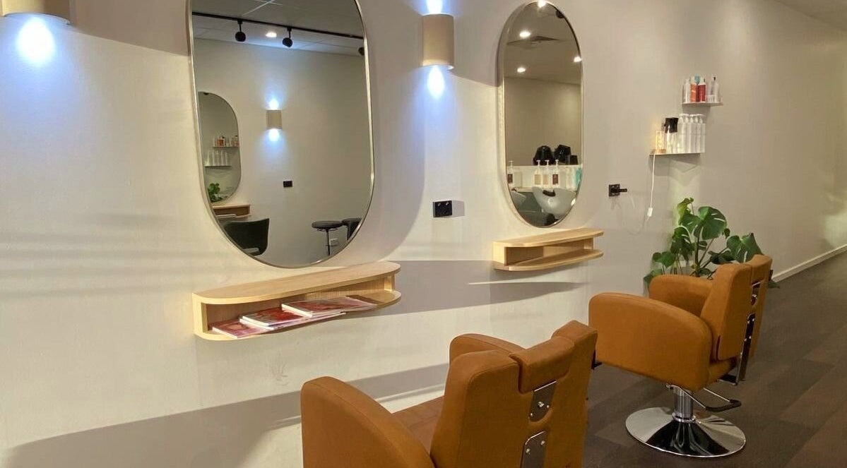 Elegant salon interior of Perth Curls, Leederville, Western Australia, AU featuring stylish stations and mirrors.