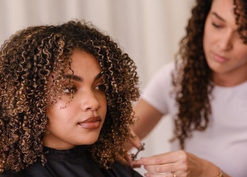 Stylist enhancing curls at Perth Curls, Leederville, Western Australia, AU.