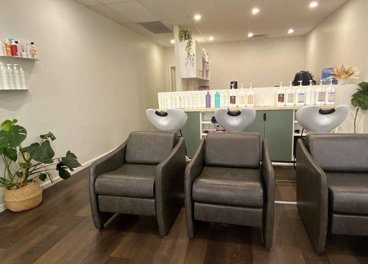 Chic salon interior at Perth Curls in Leederville, Western Australia, AU with modern wash stations and greenery.