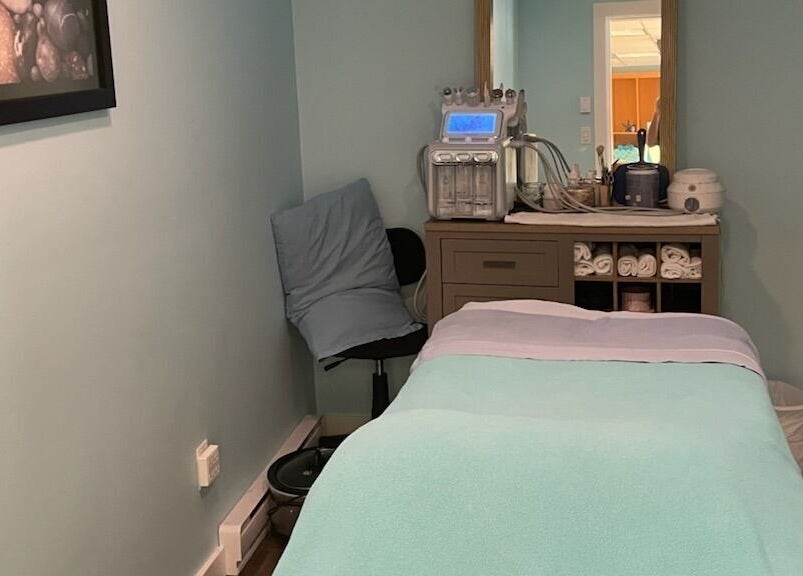 Relaxing treatment room at Ocean Blue Day Spa, Port Alberni, British Columbia, CA with massage table and equipment.